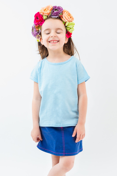 Laughing girl in blue tshirt and flowers national headdress. - Фото, изображение