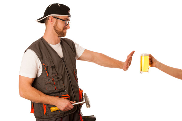 Handyman in work clothing refusing beer, don't drink on workplac - Zdjęcie, obraz