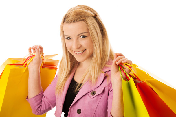 Cute blonde woman with shopping vibrant bags isolated over white - Foto, afbeelding