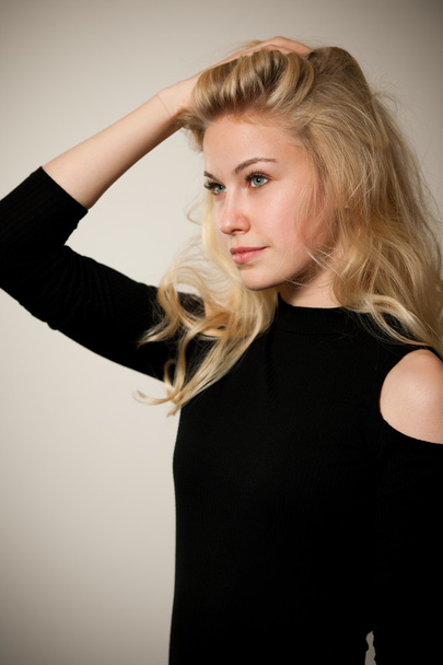 Beautiful young woman with gorgeous hairstyle posing  over white - Valokuva, kuva