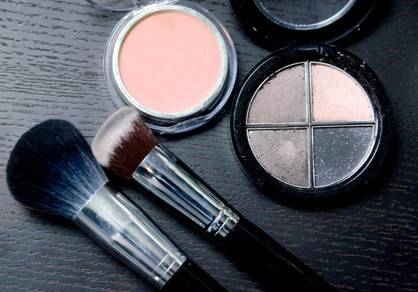 Makeup cosmetics products on wooden black background - Photo, Image