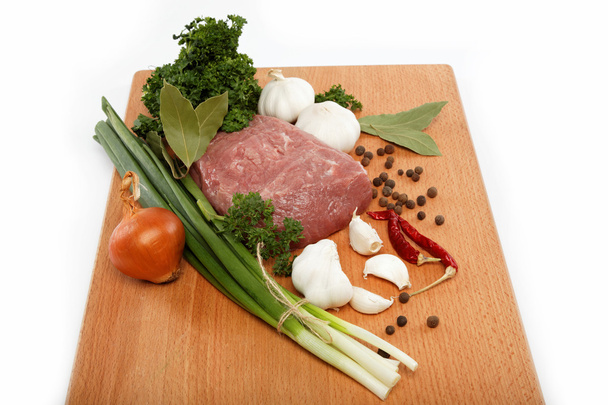 Raw meat, vegetables and spices isolated on a wooden table. - Photo, Image