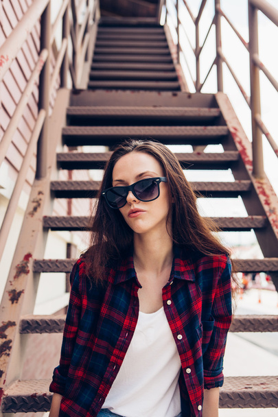 Hipster girl on metal stairs. - Zdjęcie, obraz