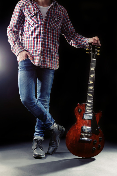 Young man with electric guitar - 写真・画像