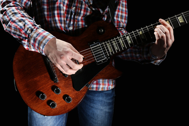 Young man playing electric guitar - Fotó, kép