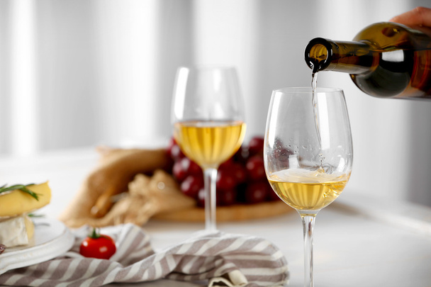 Pouring white wine into glass - Foto, Imagen