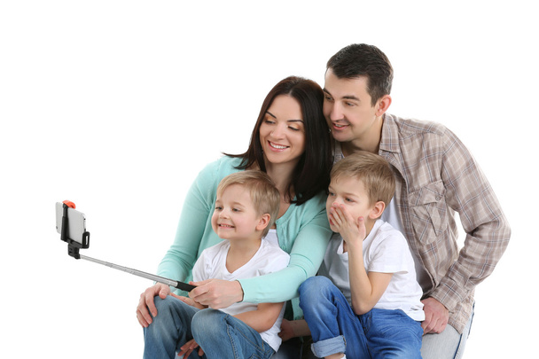 Happy family making selfie with selfie stick isolated on white - Fotoğraf, Görsel