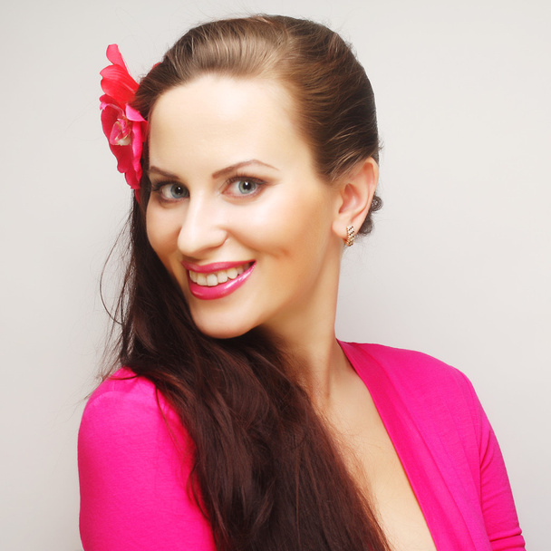 brunette with long hair in pink wear happy smiling - Foto, Imagen