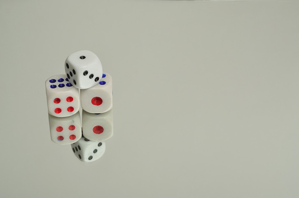 A collection of dice that is reflection onto a white background - Photo, Image
