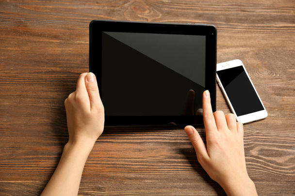 Mobile phone and female hands using tablet - Foto, Imagem