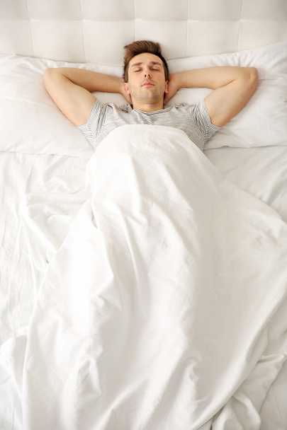 Young man sleeping alone  - Фото, изображение