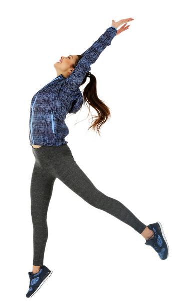 Young sporty woman jumping - Foto, afbeelding