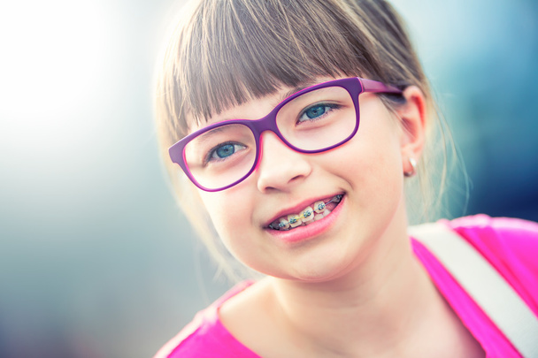 Girl. Teen. Pre teen. Girl with glasses. Girl with teeth braces. Young cute caucasian blond girl wearing teeth braces and glasses - Photo, image