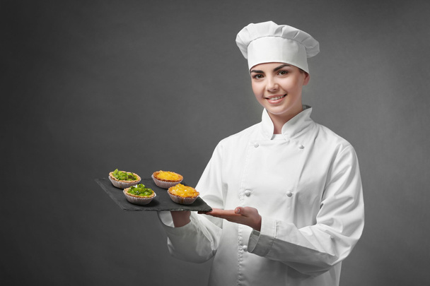 Professional chef holding  fruit tarts  - Foto, afbeelding