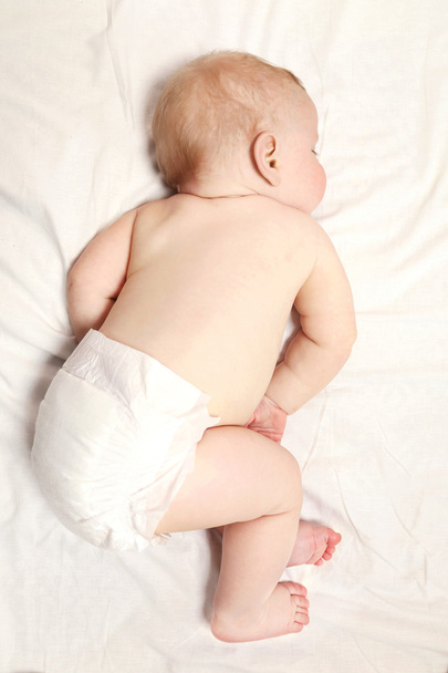 Peaceful baby sleeping in a bed - 写真・画像