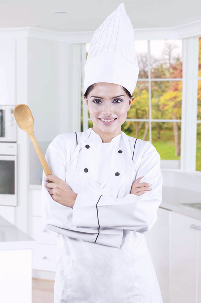 Young housewife with chef uniform and spoon - Фото, зображення