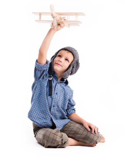 little boy with pilot hat and toy airplane - Zdjęcie, obraz