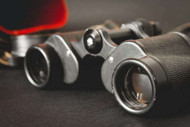 Old binoculars on black background - 写真・画像