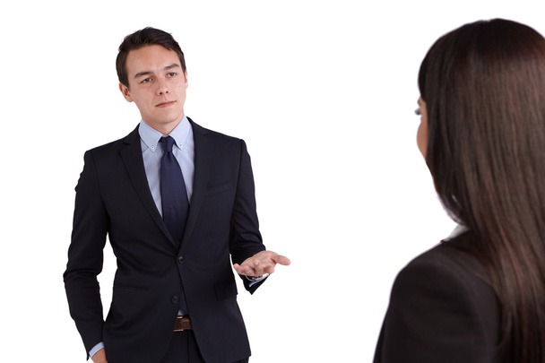 Young Caucasian business man reprimanding a business woman - Fotó, kép