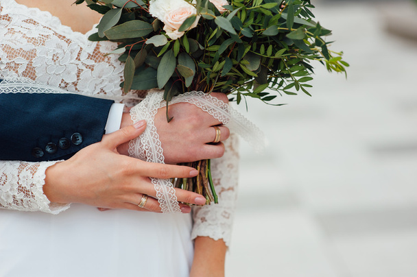 bride and groom together holding wedding bouquet - Photo, Image