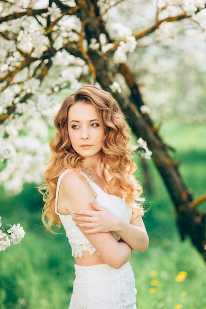 Beautiful woman in blooming garden - Valokuva, kuva