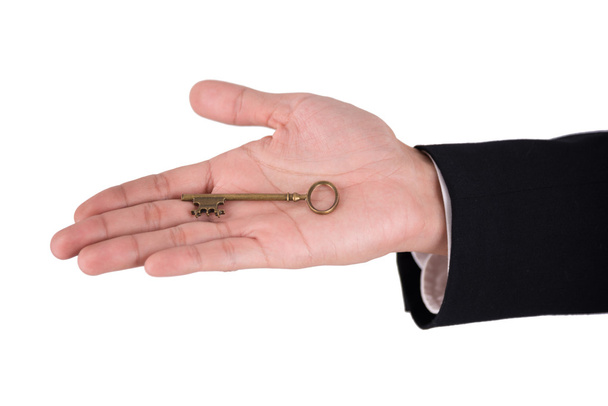 gold skeleton key in businessman hand isolated on white backgrou - Photo, image