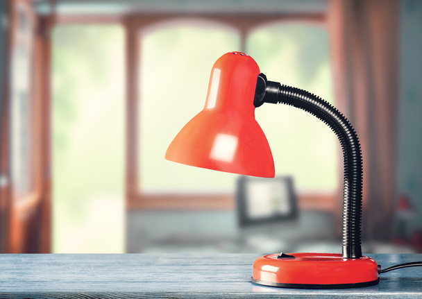 Red table-lamp on table  - 写真・画像