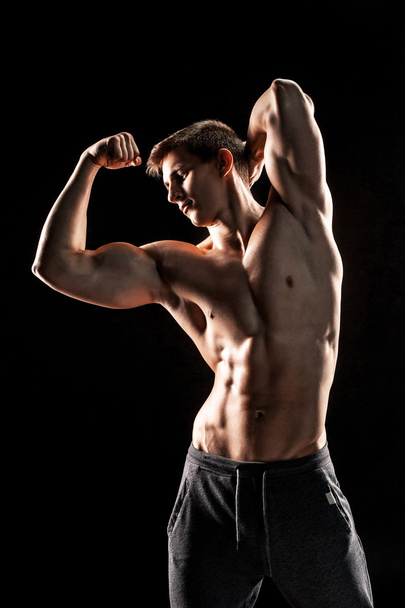 Strong man showing perfect abs, houlders, biceps, triceps and ch - 写真・画像