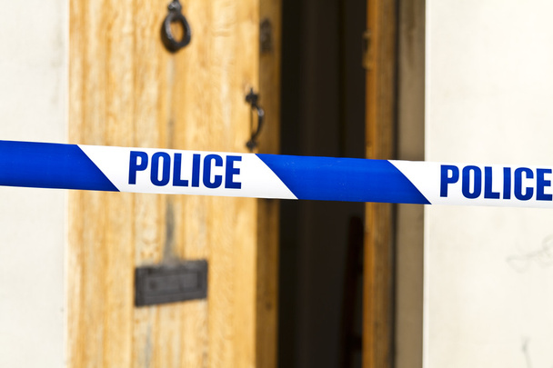 Police tape across an open door - Photo, Image