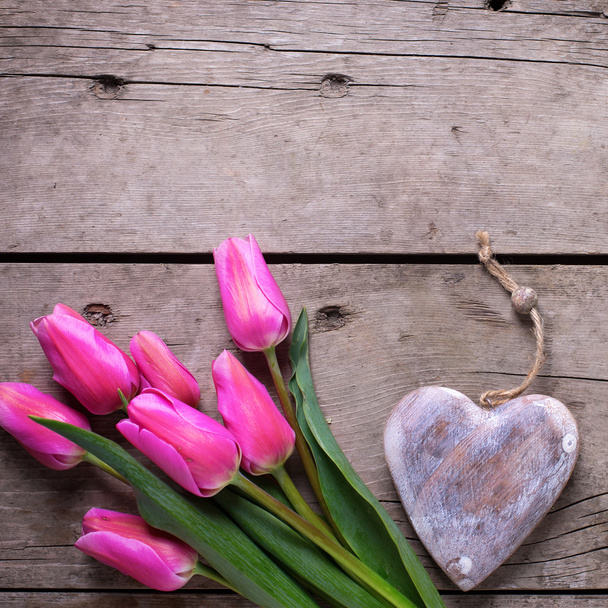 Pink tulips and decorative rustic heart - Fotografie, Obrázek