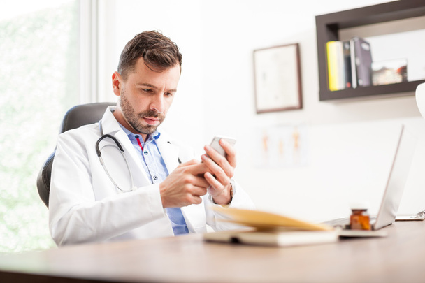 physician using a smartphone - Fotó, kép