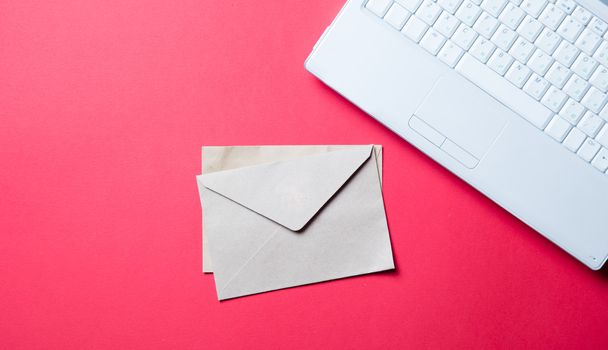 envelopes and laptop on the red  - Φωτογραφία, εικόνα