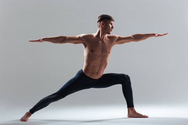 Full length portrait of a man doing yoga exercises - Fotografie, Obrázek