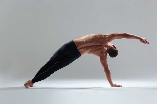 Full length portrait of a fitness man warming up - Фото, изображение