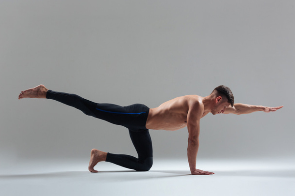 Handsome man doing stretching exercises - 写真・画像