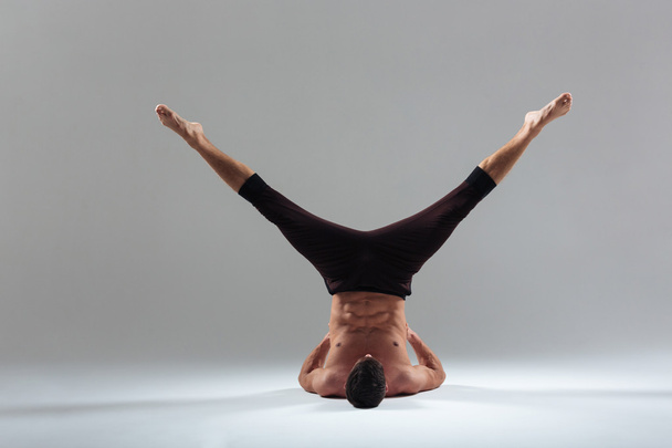 Handsome man doing yoga exercise - Valokuva, kuva