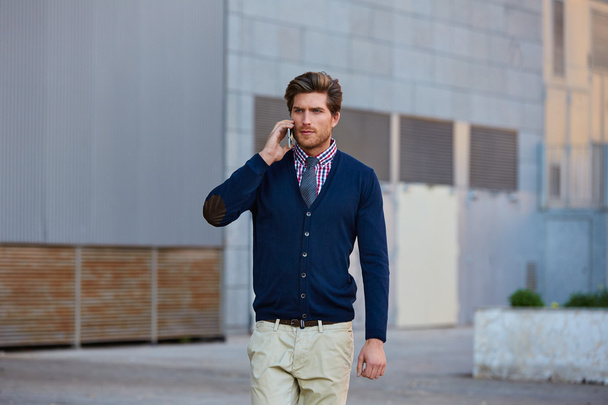 Young businessman talking smartphone walking  - Valokuva, kuva