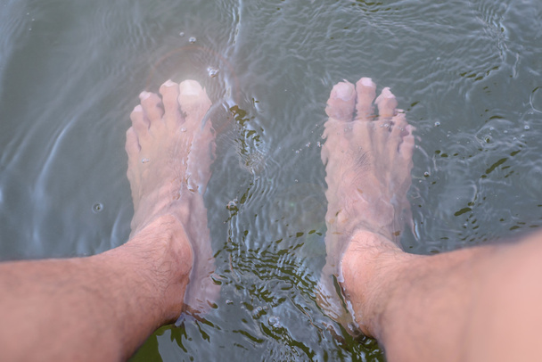 Man is using natural liquid immersion foot, which is a good way to health. - Photo, Image