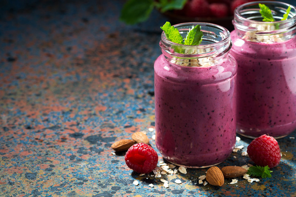 berry smoothie in a bottle on a dark background - Fotó, kép