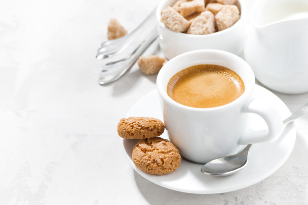 cup of espresso and almond cookies on a white table, horizontal - Foto, imagen