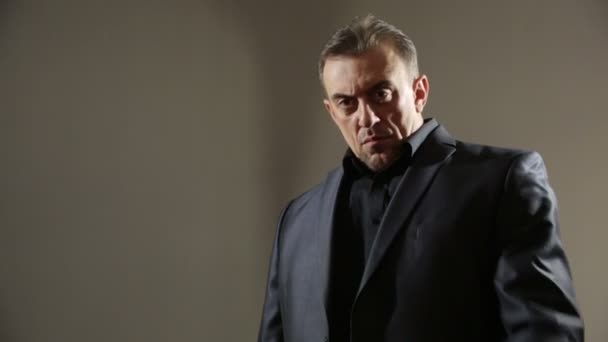 Businessman Pointing Hand Gun. gangster threatens gun. a brutal man in a business suit. aggressive gestures - Кадры, видео