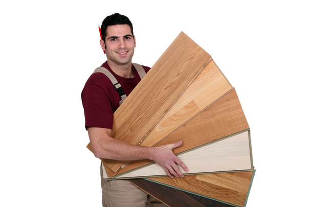 Man displaying variety of laminate flooring - Photo, Image