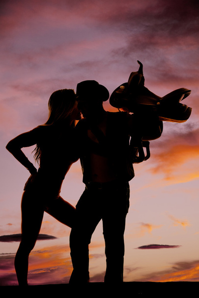 silhouette of a fit woman stand hand on chin lean forward kiss c - Foto, immagini