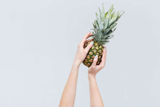 Female hands holding ananas - Fotoğraf, Görsel