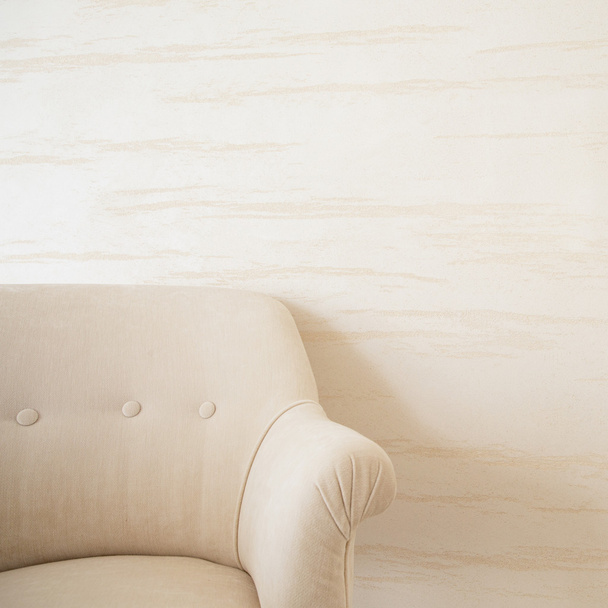Beige armchair on a background of bright wall - Foto, Imagem