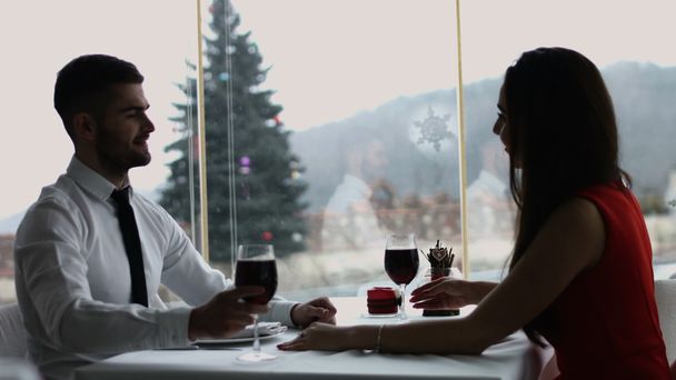 幸せな若いカップル ロマンチックなデート飲み物グラスワイン赤レストランでは、バレンタインデーを祝う - 写真・画像