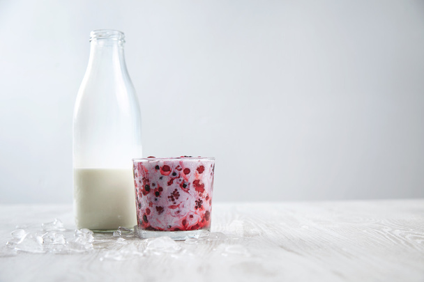 frozen berries in glass mixed with fresh milk - Zdjęcie, obraz
