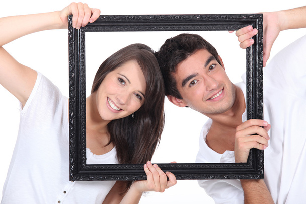 Couple behind black frame - Фото, зображення