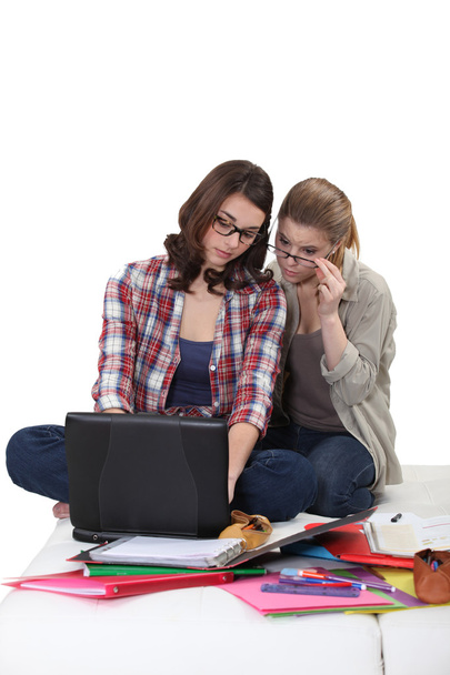Female students working at a laptop - Fotó, kép