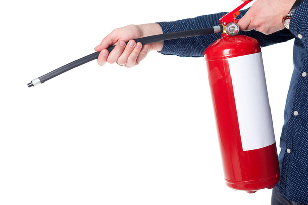 Man using fire extinguisher - Foto, afbeelding
